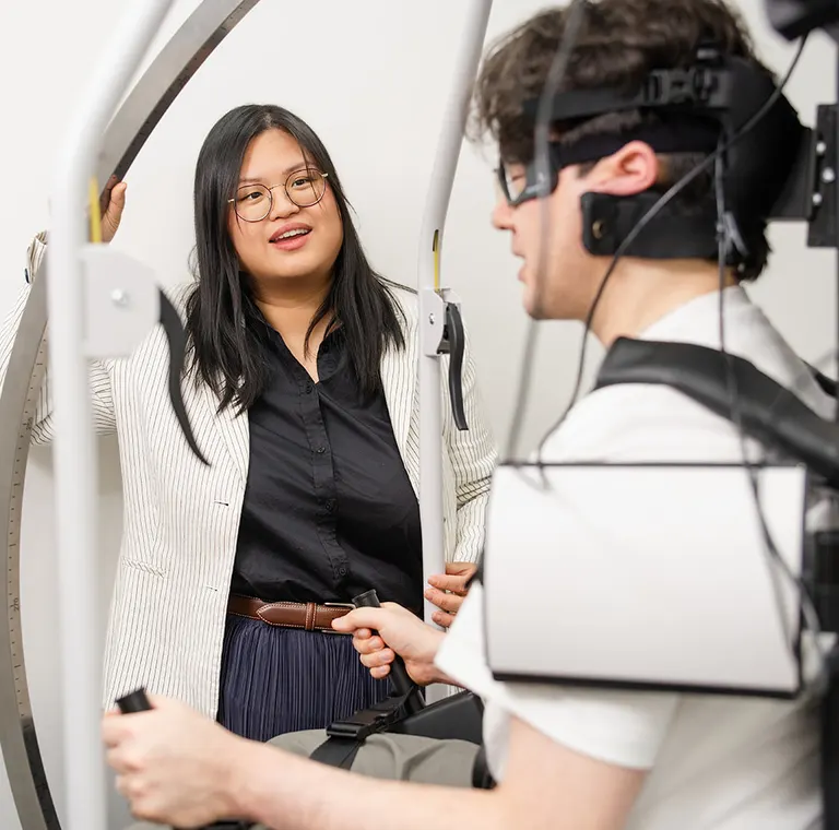 Dr Clarissa Tjoakarfa talking with a patient seated in the Rotundum positioning chair