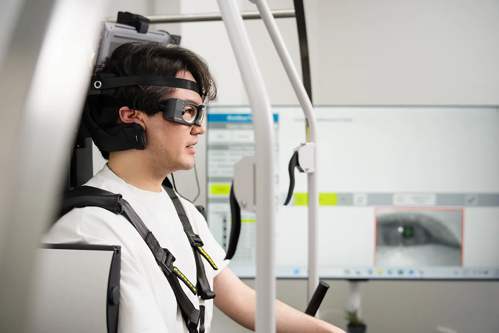 A patient wearing video goggles while being tested in the Rotundum positioning chair